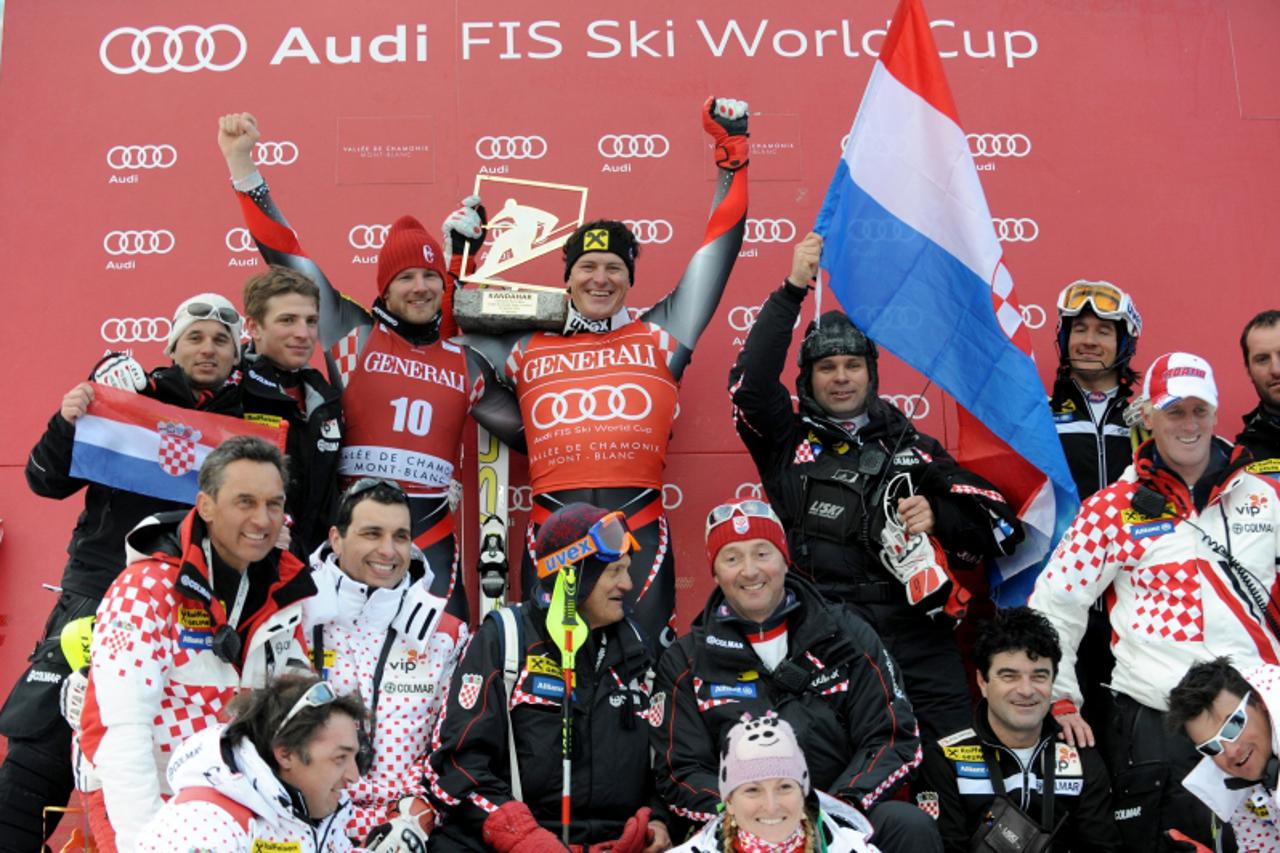 \'Croatia\'s Ivica Kosteli (C) and compatriot Natko Zrncic-Dim (up, 3rdL) celebrate with Croatia\'s team on the podium of the after the FIS World Cup super combined on January 30, 2011 in Chamonix, Fr