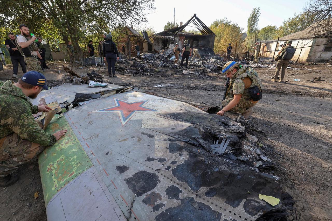 Ukrainian servicemen ride a tank near the Russian border in Sumy region