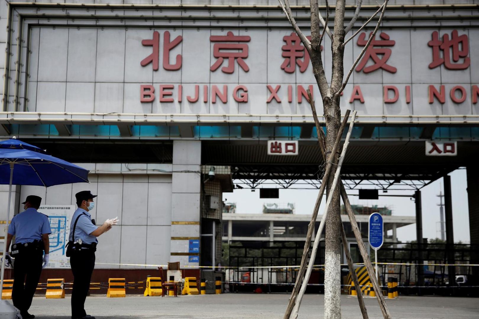 Police officers wearing face masks stand guard outside an entrance to the Xinfadi wholesale market in Beijing Police officers wearing face masks and gloves stand guard outside an entrance to the Xinfadi wholesale market, which has been closed following cases of coronavirus disease (COVID-19) infections, in Beijing, China June 16, 2020.  REUTERS/Tingshu Wang TINGSHU WANG