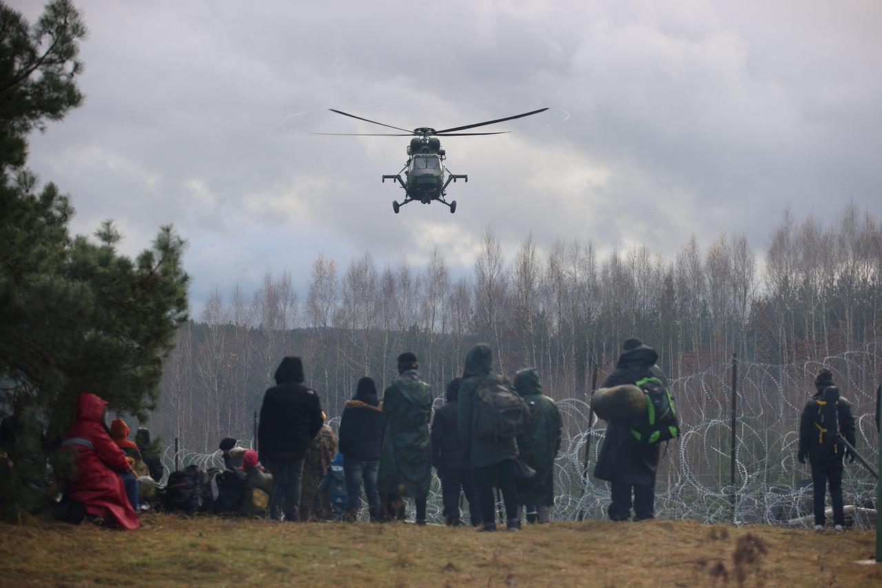 Migrants gather on the Belarusian-Polish border