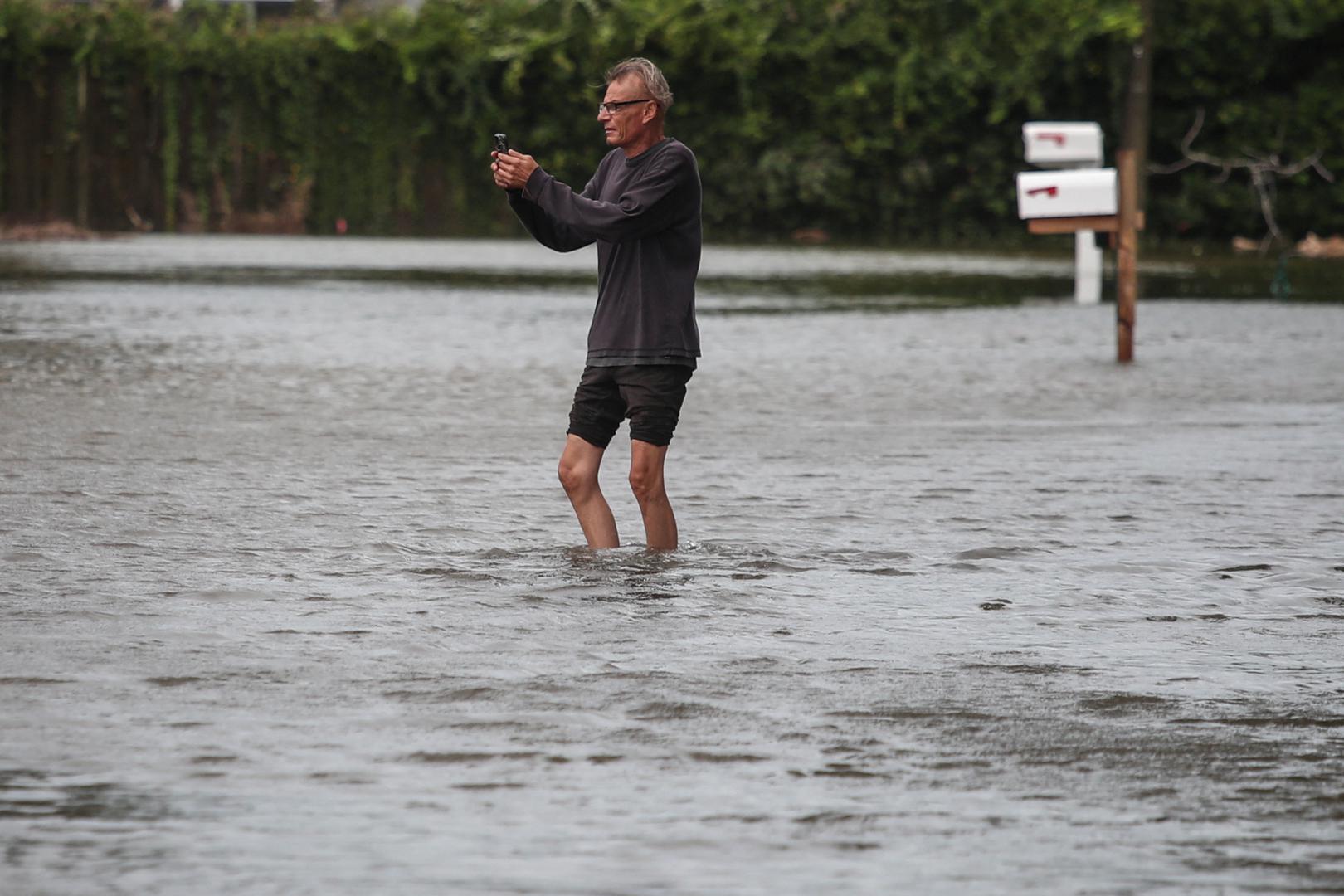 Victor Cristia, 59, stands in flood waters caused by Hurricane Idalia while photographing his residence in Clearwater Beach, Florida, U.S., August 30, 2023. REUTERS/Adrees Latif Photo: ADREES LATIF/REUTERS