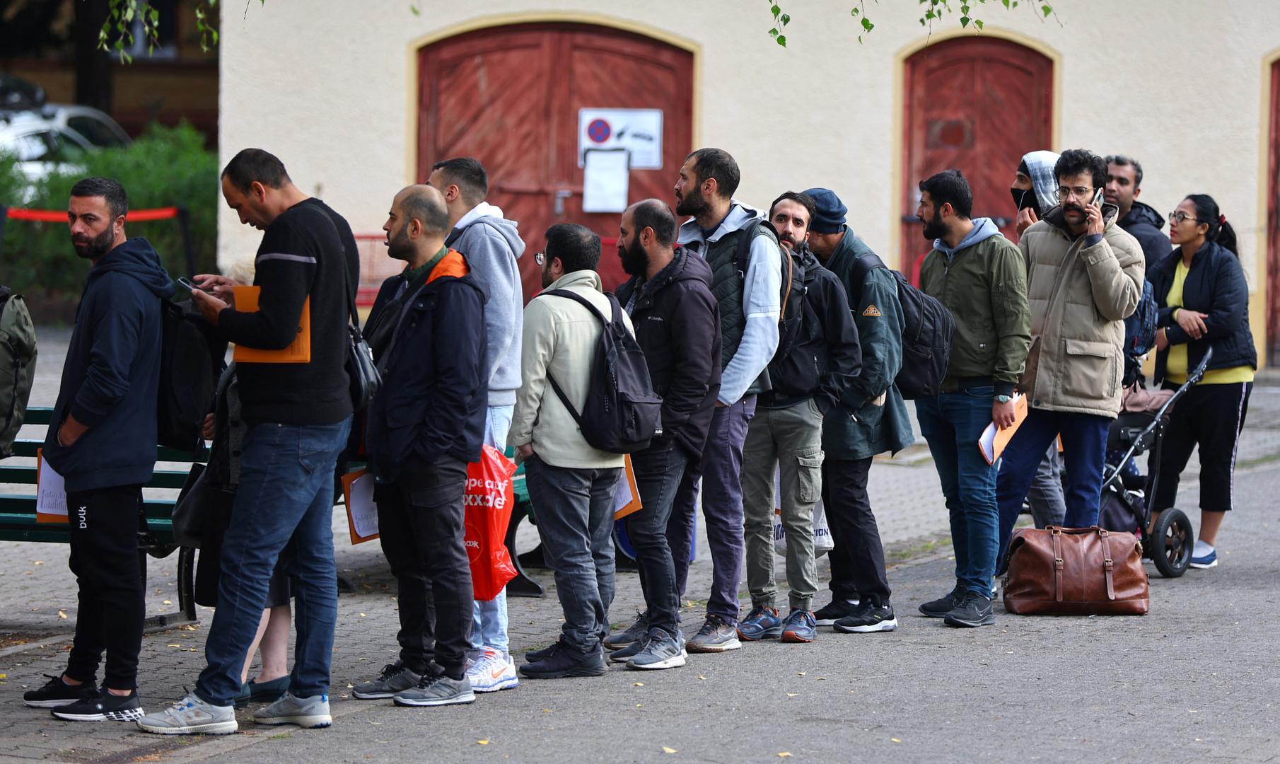 Migrants queue in a waiting area to be escorted to a registration office at the arrival centre for asylum seekers in Reinickendorf district, Berlin, Germany, October 6, 2023. REUTERS/Fabrizio Bensch Photo: Fabrizio Bensch/REUTERS