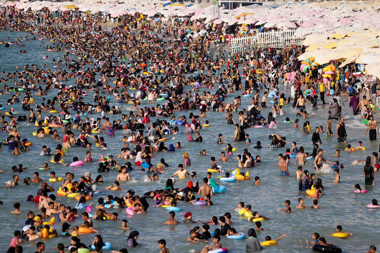 People crowd a public beach during a hot day amid a heatwave, in the Mediterranean city of Alexandria