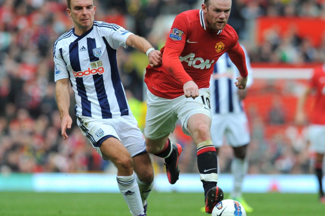 \'Manchester United\'s English forward Wayne Rooney (R) fights for the ball with West Bromwich Albion\'s Scottish midfielder James Morrison on March 11 2012 during an English Premier League football m