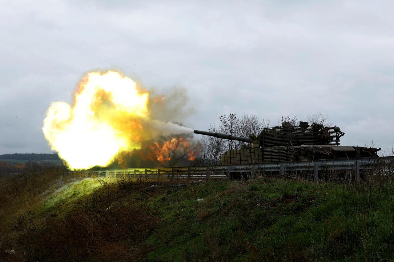 Ukrainian soldiers fires a round from a former Russian tank, in Bakhmut