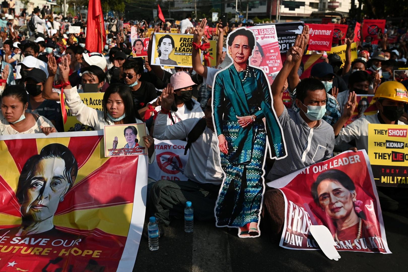 Protest against the military coup, in Yangon Demonstrators hold placards with the image of Aung San Suu Kyi during a protest against the military coup in Yangon, Myanmar, February 15, 2021. REUTERS/Stringer STRINGER