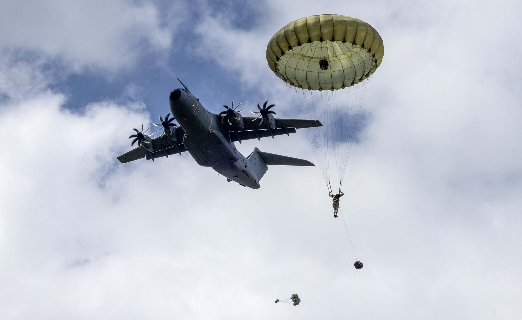 Paratroopers make a commemorative jump into fields around the French village of Sanneville in Normandy as part of the 80th anniversary of D-day.  05.06.2024   Material must be credited "The Times/News Licensing" unless otherwise agreed. 100% surcharge if not credited. Online rights need to be cleared separately. Strictly one time use only subject to agreement with News Licensing Photo: Richard Pohle/NEWS SYNDICATION