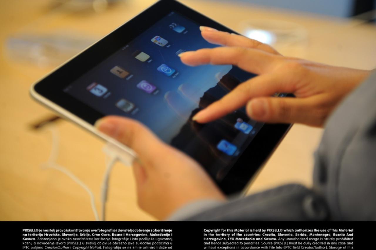 'An early customer emerges from the Apple store on Fifth Avenue with Apple Inc\'s new iPad. Hundreds lined up in front of the technology company\'s flagship New York store to be among the first in the