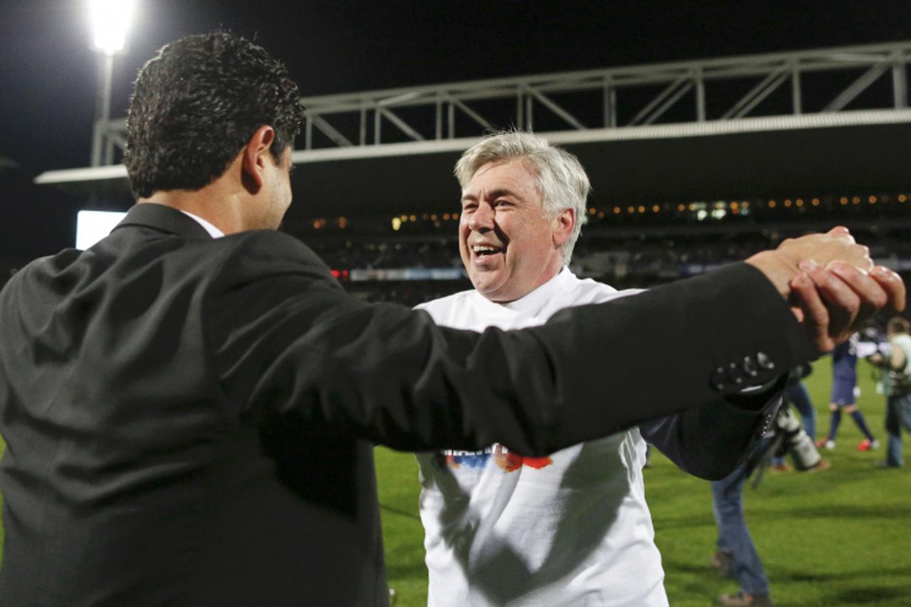 'Paris Saint-Germain's owner of Qatari TV channel Al Jazeera Sport and PSG club owner Nasser Al-Khelaifi (L) celebrates with coach Carlo Ancelotti at the end of their team's French Ligue 1 soccer ma