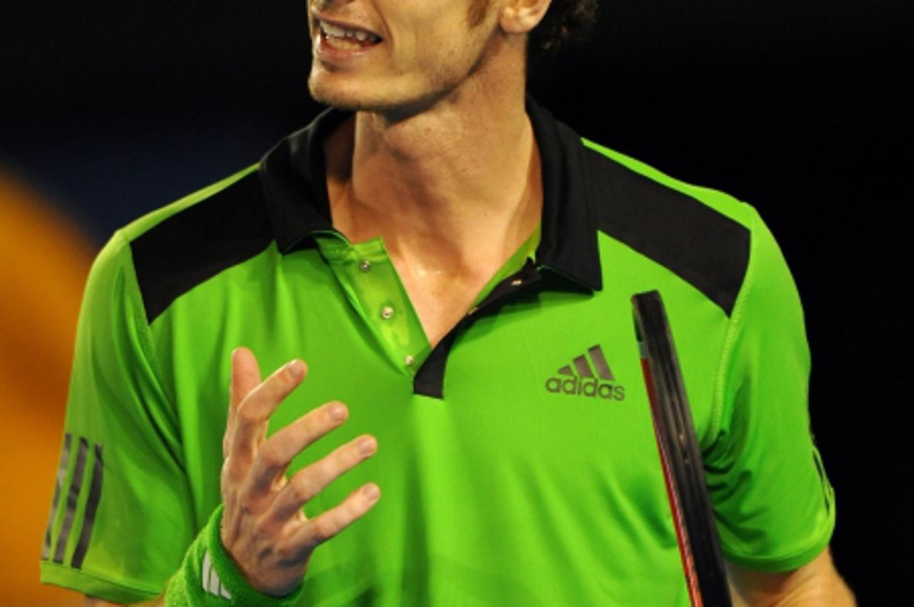 'Andy Murray of Britain reacts after a point against Novak Djokovic of Serbia in their men\'s singles final on the fourteenth day of the Australian Open tennis tournament in Melbourne on January 30, 2