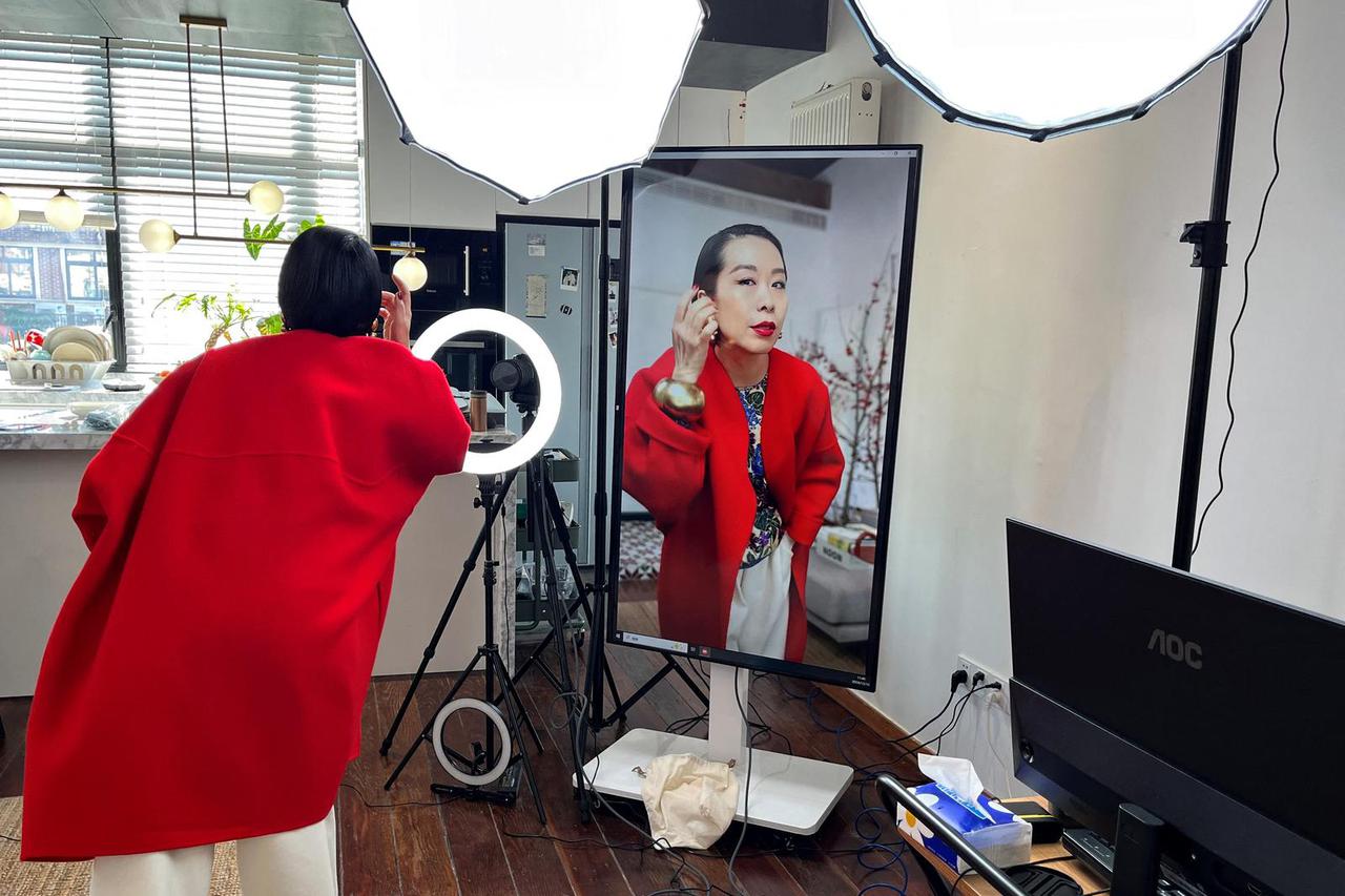 Influencer Tera Feng prepares before hosting a livestream sales session on the social media platform Xiaohongshu, in Shanghai