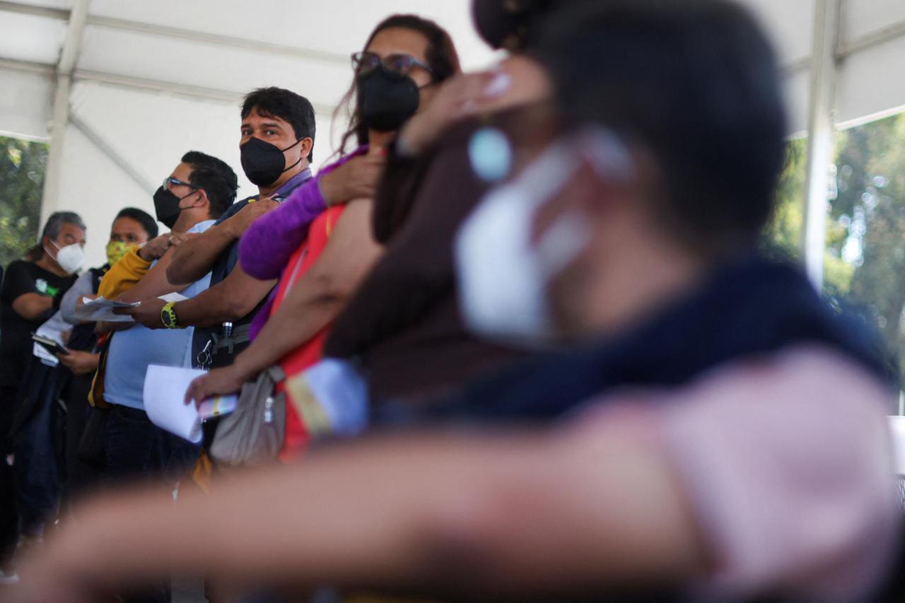 Teachers receive a booster shot of the Moderna coronavirus disease (COVID-19) vaccine in Mexico City