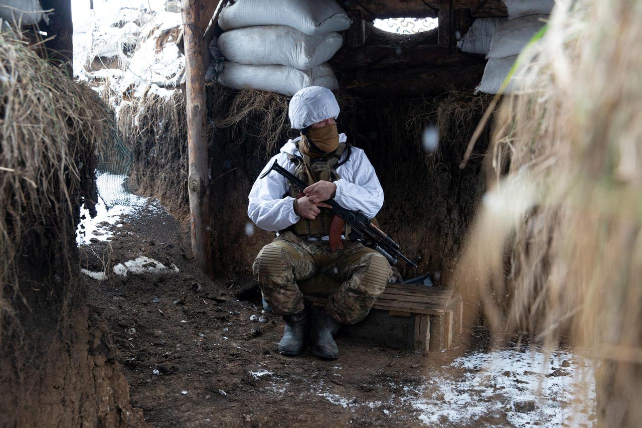 A service member of the Ukrainian armed forces is seen at combat positions in Donetsk region