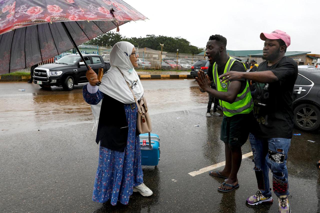 A traveller speaks to members of the National Association of Nigerian Students (NANS) as they protest against prolonged strike action of the Academic Staff Union of Universities in Lagos