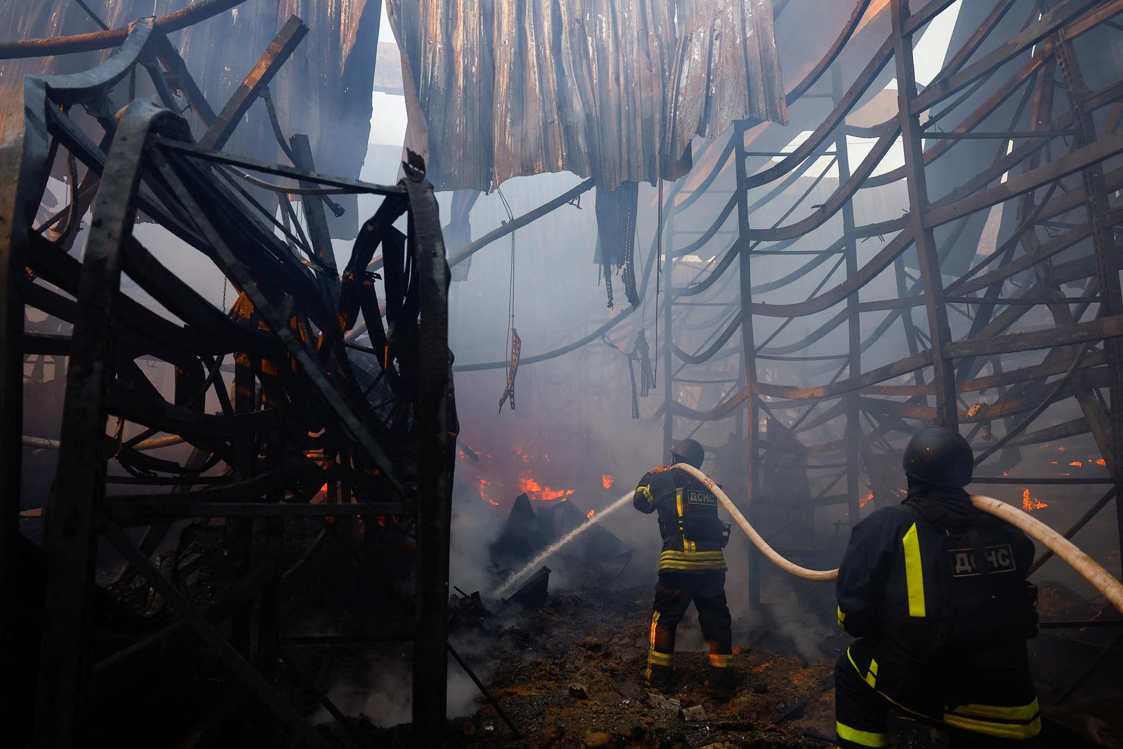 Firefighters work at the site of a household item shopping mall which was hit by a Russian air strike, amid Russia's attack on Ukraine, in Kharkiv, Ukraine, May 25, 2024. REUTERS/Valentyn Ogirenko Photo: VALENTYN OGIRENKO/REUTERS