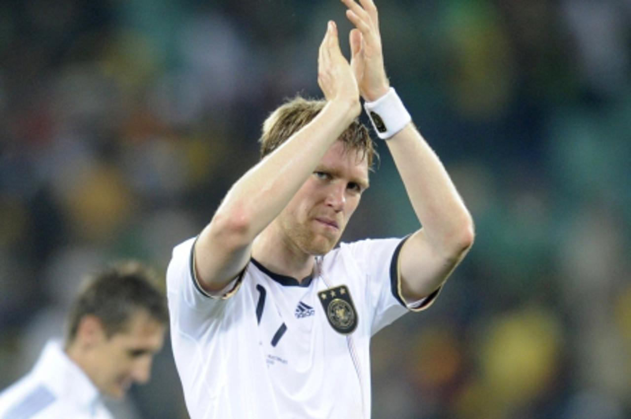 'Germany\'s defender Per Mertesacker acknowledges fans as he walks off the pitch at the end of their Group D first round 2010 World Cup football match against Australia on June 13, 2010 at Moses Mabhi