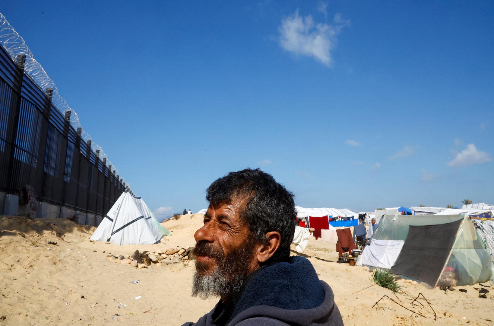 Displaced Palestinian man Naser Abu Mustafa, who fled his house due to Israeli strikes, looks on as he shelters at the border with Egypt, in Rafah in the southern Gaza Strip, February 10, 2024. REUTERS/Mohammed Salem Photo: MOHAMMED SALEM/REUTERS