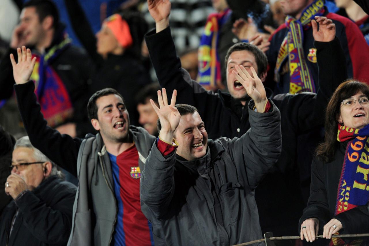 'Barcelona fans celebrate after Argentinian forward Lionel Messi scored his fourth goal during the Champions League quarter-final second-leg match at Camp Nou stadium in Barcelona on April 6, 2010. Li