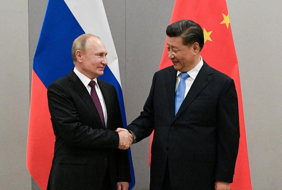 FILE PHOTO: Russian President Putin meets with Chinese President Xi during their meeting on the sideline of the BRICS summit in Brasilia