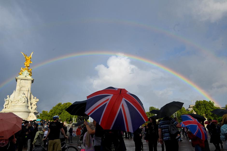 People gather outside Buckingham Palace in London