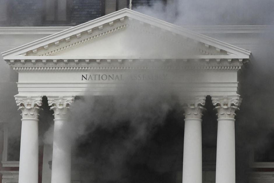 Smoke rises from the building of the Parliament in Cape Town