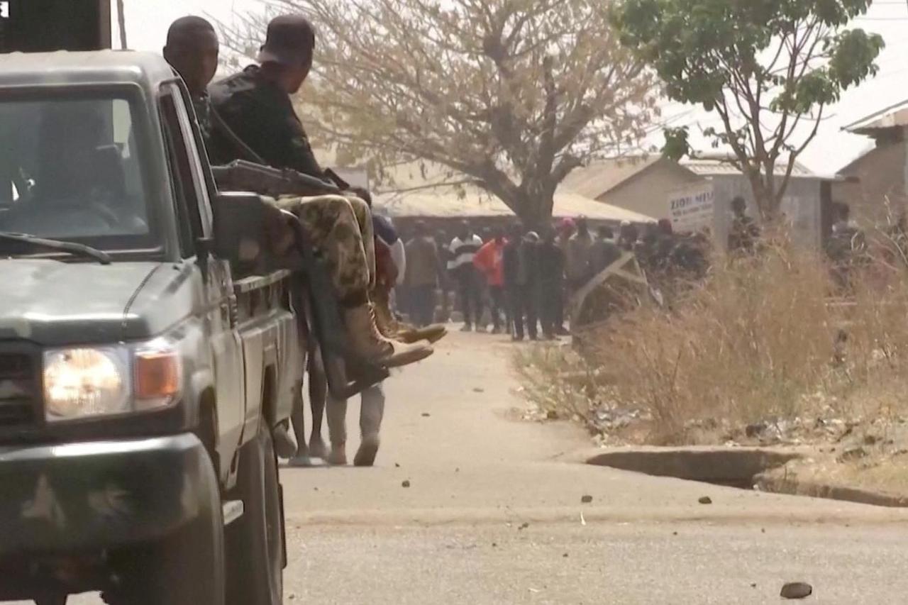 Security personnel patrol the streets amid a surge in violence in Mangu