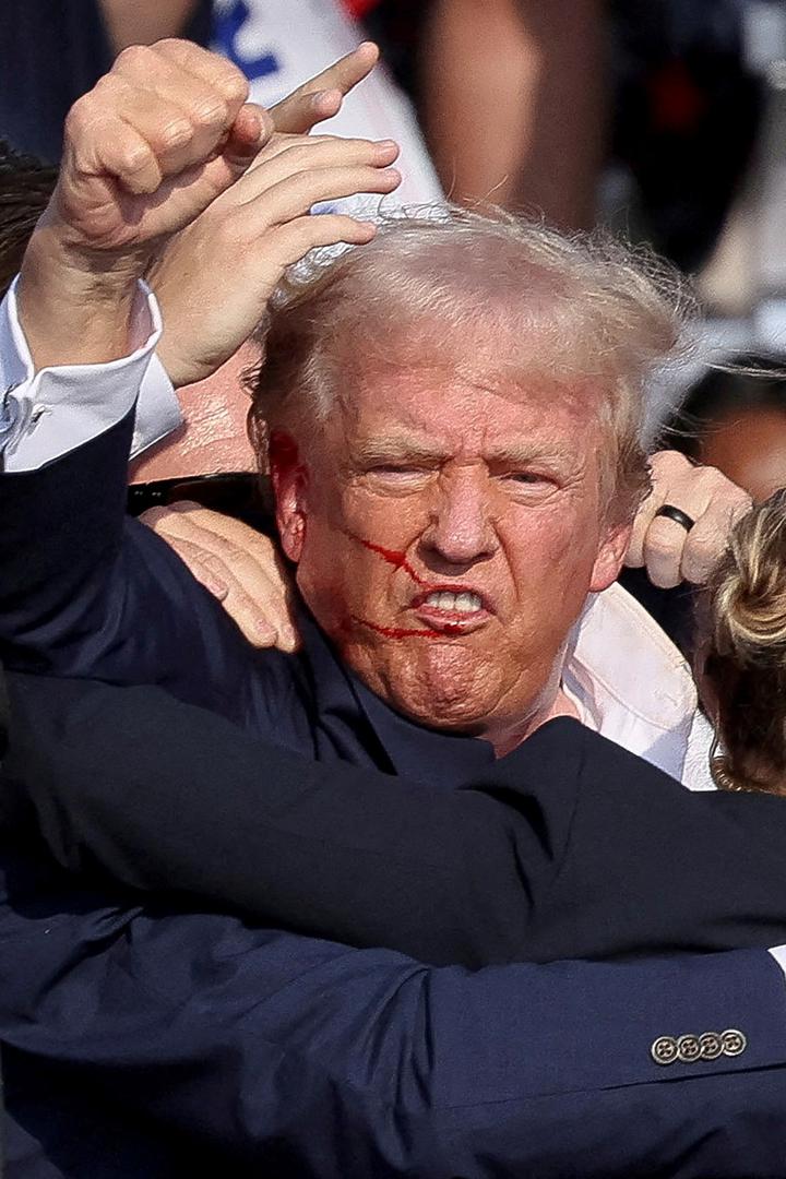 Republican presidential candidate and former U.S. President Donald Trump is assisted by the Secret Service after gunfire rang out during a campaign rally at the Butler Farm Show in Butler, Pennsylvania, U.S., July 13, 2024. REUTERS/Brendan McDermid Photo: BRENDAN MCDERMID/REUTERS