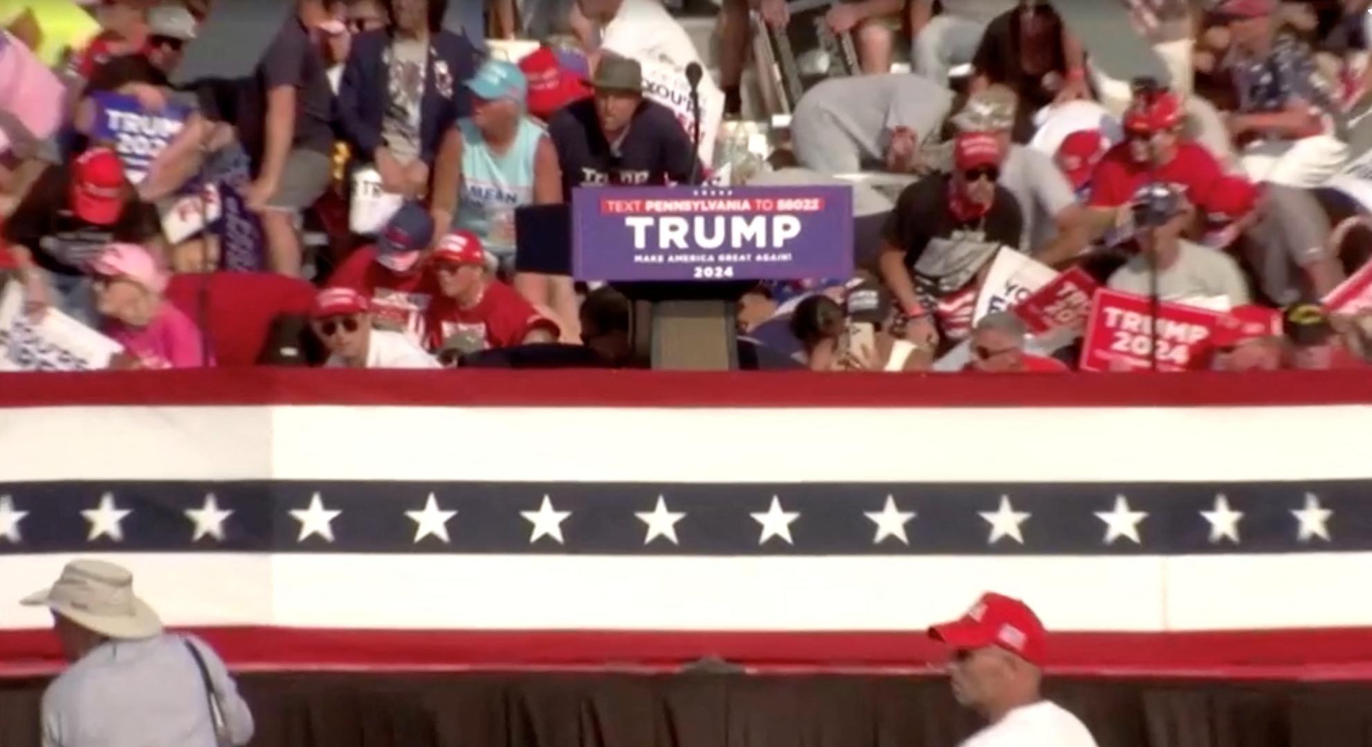 People crouch during a rally for Republican presidential candidate and former U.S. President Donald Trump after gunfire rang out at the Butler Farm Show in Butler, Pennsylvania, U.S., July 13, 2024, in this screen grab taken from a video. ABC/US Network Pool/ Handout via REUTERS ATTENTION EDITORS - THIS PICTURE WAS PROVIDED BY A THIRD PARTY. NO RESALES. NO ARCHIVES. MANDATORY CREDIT. Photo: ABC/US Network Pool/REUTERS