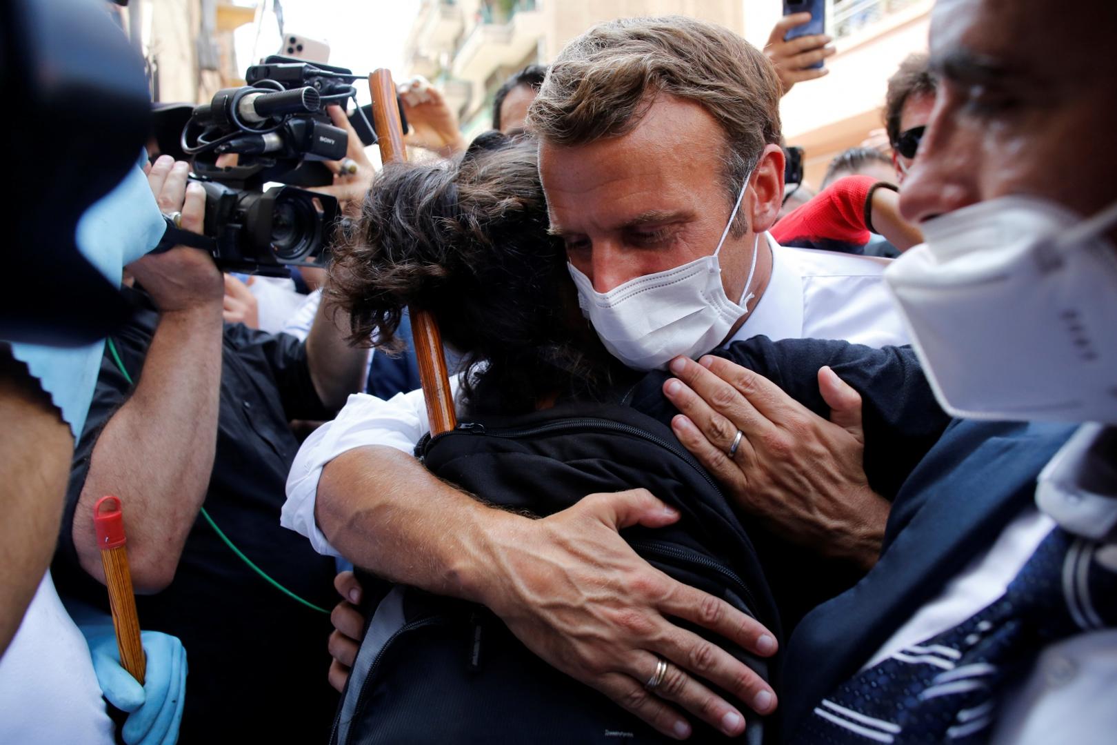 French President Emmanuel Macron visits devastated streets of Beirut French President Emmanuel Macron hugs a resident as he visits a devastated street of Beirut, Lebanon August 6, 2020. Thibault Camus/Pool via REUTERS POOL