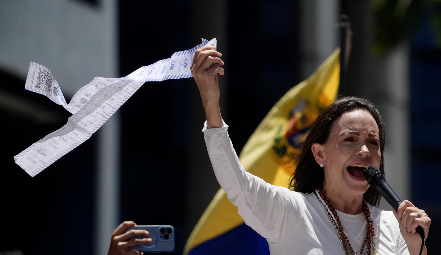 Venezuelan opposition leader Maria Corina Machado speaks as she holds up a copy of electoral records during a protest against the election results announced by President Nicolas Maduro's government after he was declared winner of the election, in Caracas, Venezuela, August 28, 2024. REUTERS/Maxwell Briceno Photo: Maxwell Briceno/REUTERS