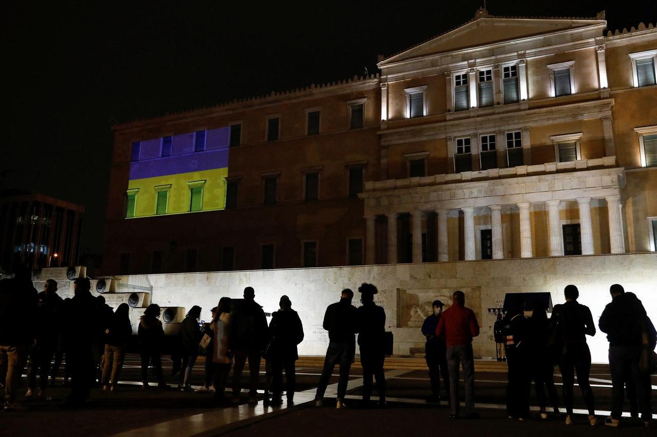 The colours of the Ukrainian flag are projected on the facade of the parliament building, in Athens