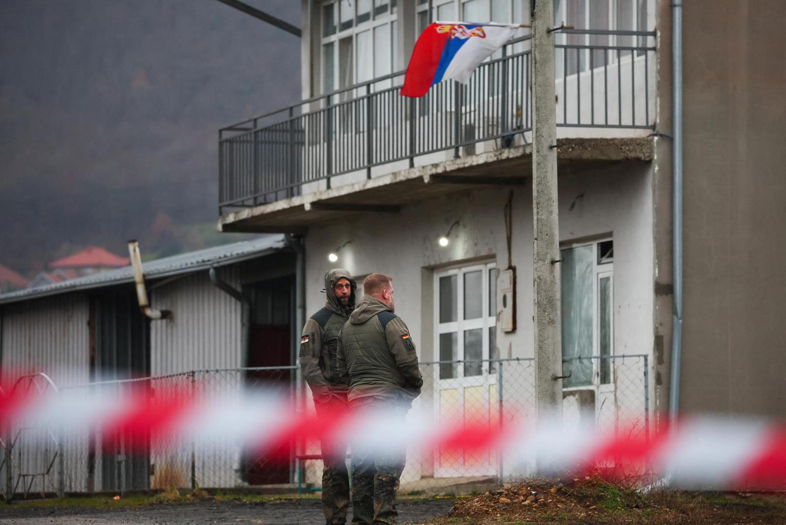 German soldiers that are part of NATO peacekeepers mission in Kosovo walk near a roadblock set up by local Serbs in Rudare, near the northern part of the ethnically-divided town of Mitrovica, Kosovo, December 12, 2022. REUTERS/Florion Goga Photo: Florion Goga/REUTERS