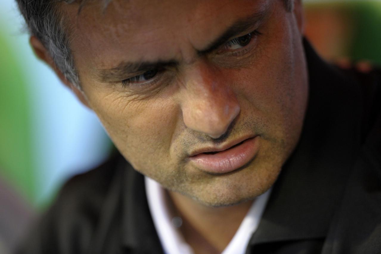 'Real Madrid\'s Portuguese coach Jose Mourinho is pictured in the bench before the start of the Spanish league football match Racing vs Real Madrid on september 21, 2011, at El Sardinero Stadium in Sa