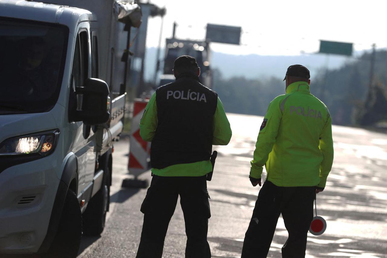 Slovakian police check a vehicle at the Slovakia-Hungary border in Sahy