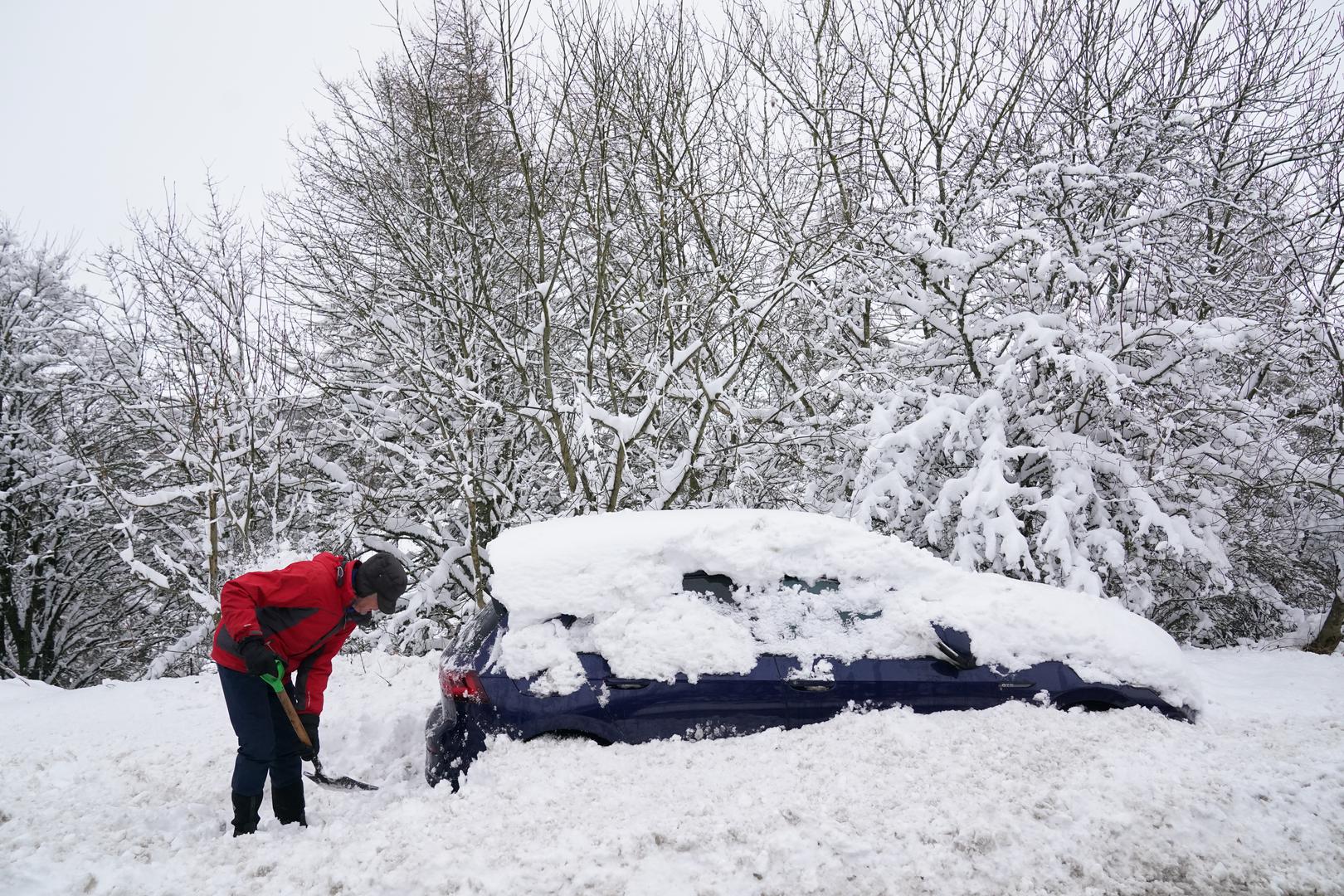 A man digs a car out of the snow near Allenheads, in the Pennines in Northumberland. Weather warnings remain in force across much of the UK on Monday with adverse conditions, including flooding from heavy rain and thawing snow. Picture date: Monday January 6, 2025. Photo: Owen Humphreys/PRESS ASSOCIATION