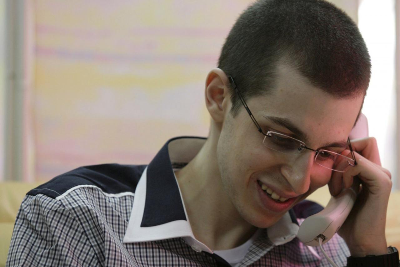 'Gilad Shalit speaks to his family on the telephone in this handout released by the Israeli Defense Forces (IDF) October 18, 2011. Israeli soldier Shalit returned home to a national outpouring of joy 