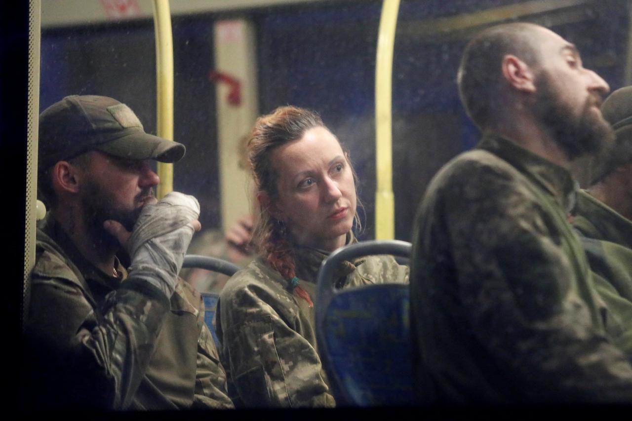 Buses carrying service members of Ukrainian forces who have surrendered after weeks holed up at Azovstal steel works arrive in Olenivka