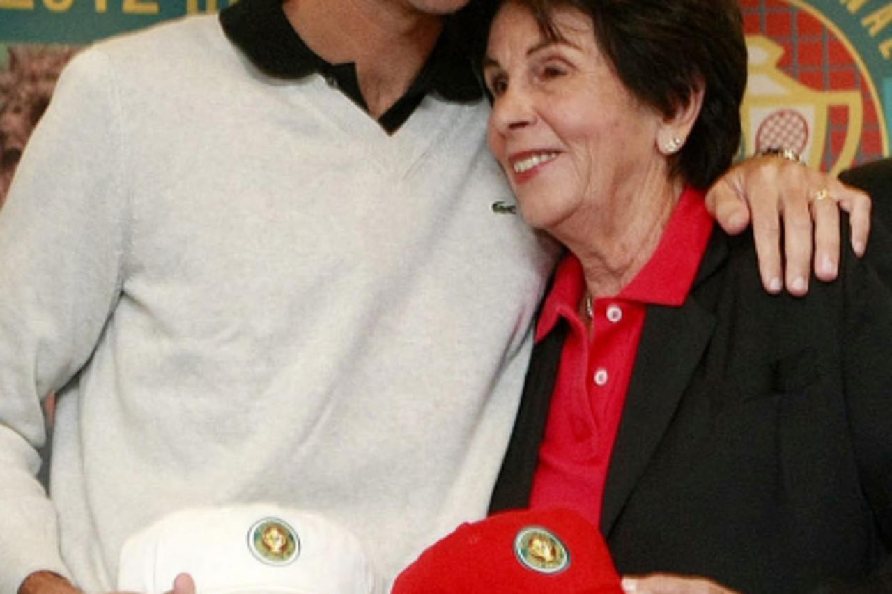 'Former world No 1 tennis player, Gustavo Kuerten (L), known as Guga, greets former tennis player Mari Esther Bueno during a press conference at the Banco do Brasil headquarters, in Paulista Avenue, i