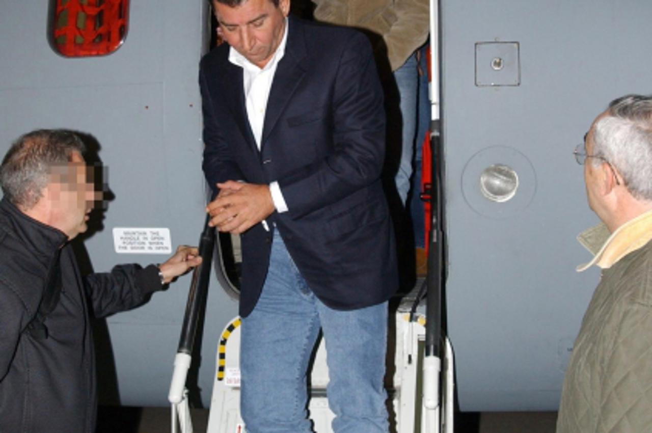 'A Spanish police handout photo shows UN war crimes court suspect, former Croatian General Ante Gotovina (C), arriving late 08 December 2005 in Madrid after his arrest 07 December 2005 in Tenerife, Ca