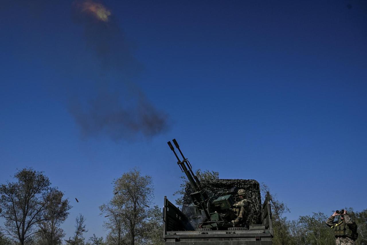 Ukrainian servicemen fire ZU-23-2  anti-aircraft cannon towards a Russian unmanned aerial vehicle near a frontline, amid Russia's attack on Ukraine in Zaporizhzhia region