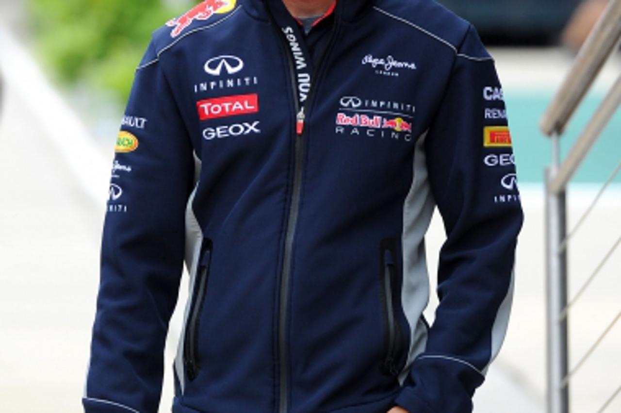 'Red Bull driver Sebastien Vettel walks through the paddock during the Paddock Day for the 2013 Santander British Grand Prix at Silverstone Circuit, Towcester.Photo: Press Association/PIXSELL'