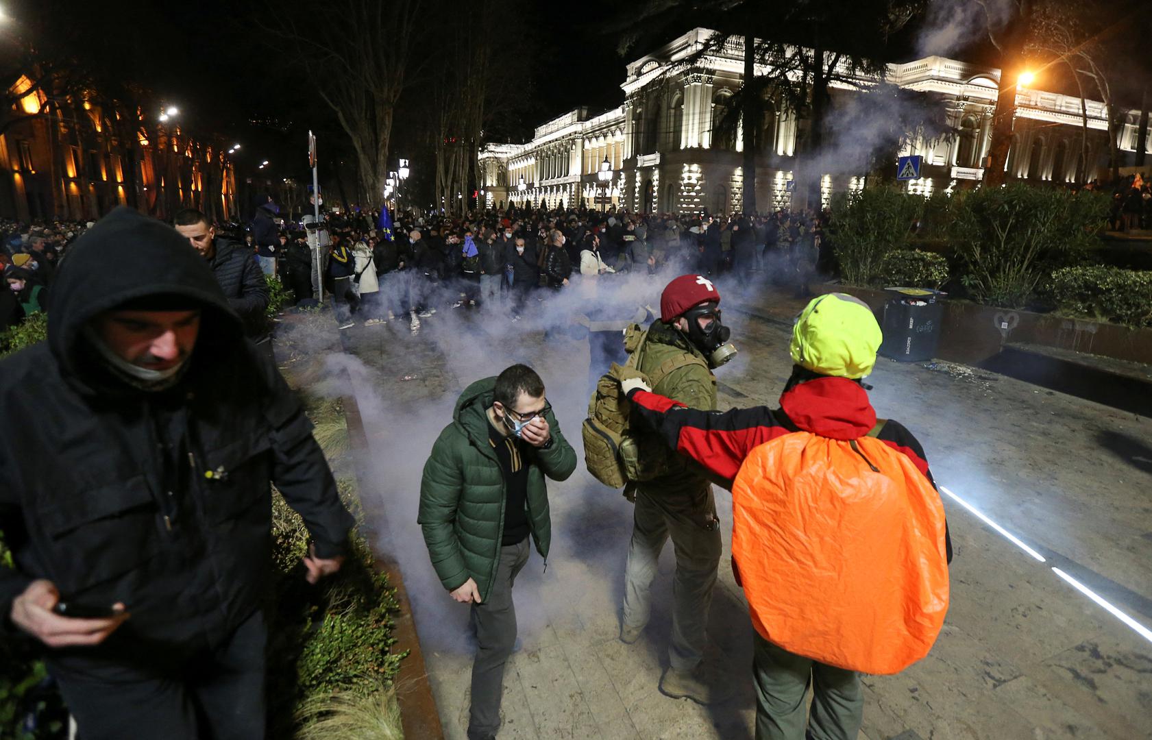 Protesters wear masks, as police use tear gas to disperse the crowd outside the parliament building during a rally against the "foreign agents" law in Tbilisi, Georgia, March 7, 2023. REUTERS/Irakli Gedenidze Photo: IRAKLI GEDENIDZE/REUTERS