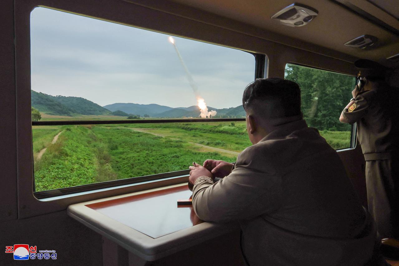 North Korean leader Kim Jong Un oversees a test-fire for a new 600mm multiple rocket launcher