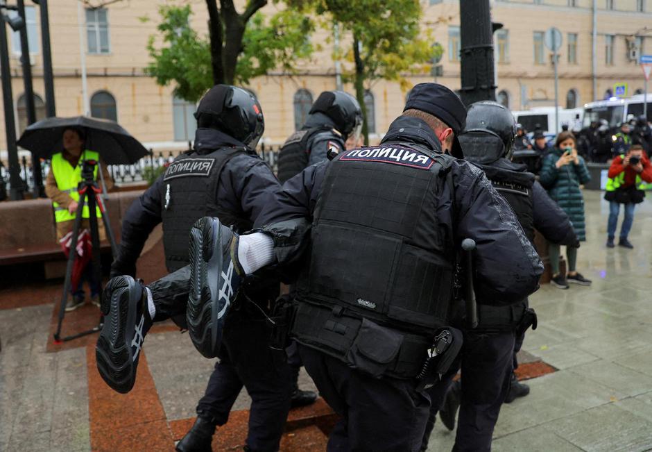 FILE PHOTO: Russian police officers detain a person during a rally in Moscow