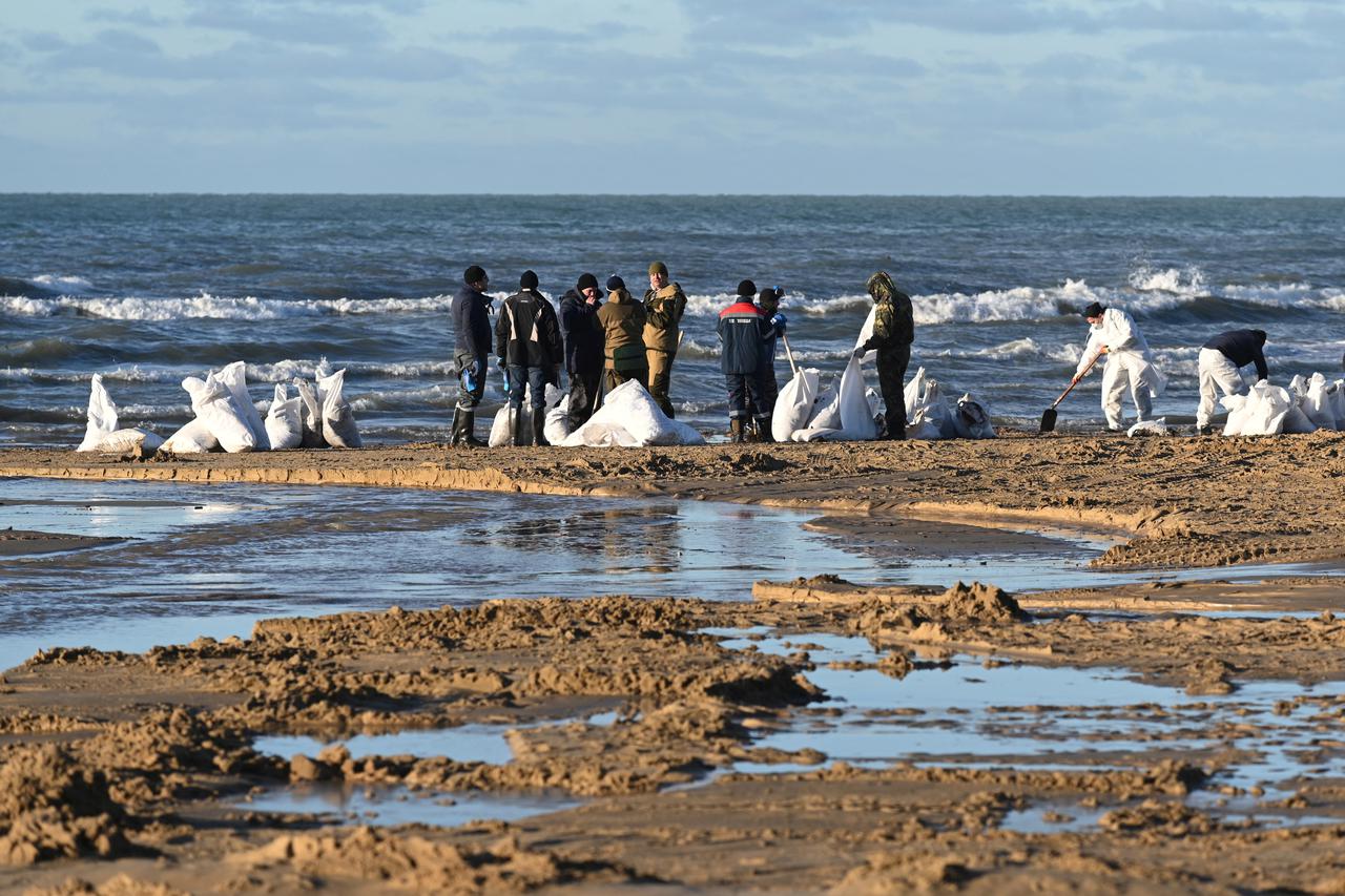 Volunteers clean a beach after an oil spill in the Black Sea, in Vityazevo