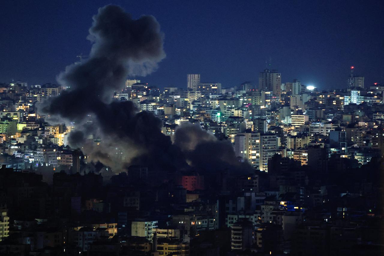 Smoke billows over Beirut's southern suburbs, after an Israeli strike, as seen from Baabda