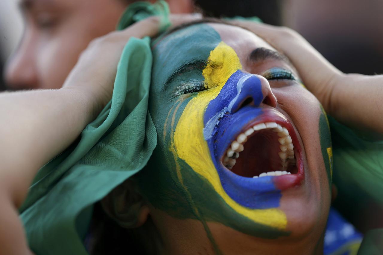 Fans of Brazil react while watching a broadcast of the 2014 World Cup semi-final against Germany at the Fan Fest in Brasilia, July 8, 2014.   REUTERS/Ueslei Marcelino (BRAZIL  - Tags:  SOCCER SPORT WORLD CUP TPX IMAGES OF THE DAY)