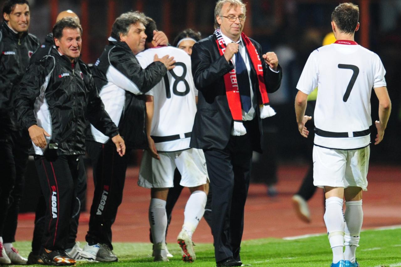 'Albania\' s coach Josip Kuze (C) celebrates with team players at the end of their Euro 2012 qualifying football match against Romania in Piatra-Neamt city, some 350km north of Bucharest, on September