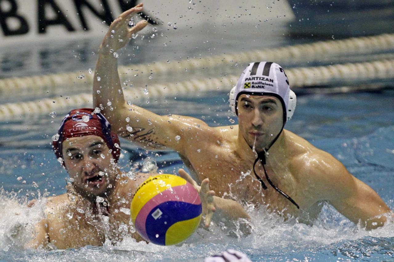 'Niksa Dobud (L) of Jug Dubrovnik struggles for the ball with Nikola Radjen of Partizan Belgrade during their Euroleague quarterfinal water polo match in Belgrade March 9, 2011. REUTERS/Ivan Milutinov