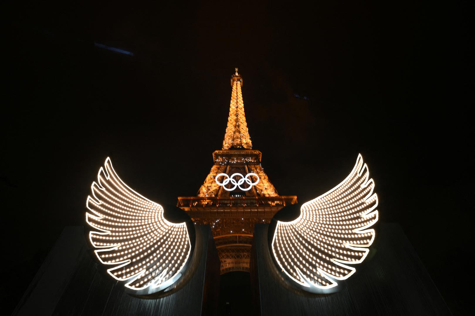 Paris 2024 Olympics - Opening Ceremony - Paris, France - July 26, 2024. A view shows the Eiffel Tower with illuminated wings in foreground after the opening ceremony of the Paris 2024 Olympic Games.    LUIS ROBAYO/Pool via REUTERS Photo: LUIS ROBAYO/REUTERS